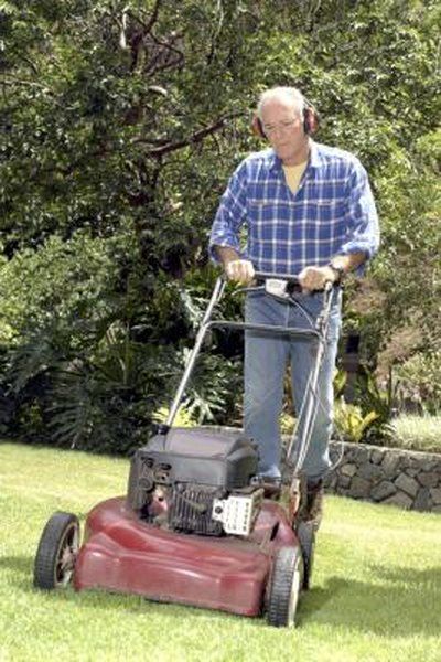 Man Mowing yard with ear protection